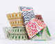 Pile of Christopher Farr Cloth Lampshades in our colourful patterned fabrics